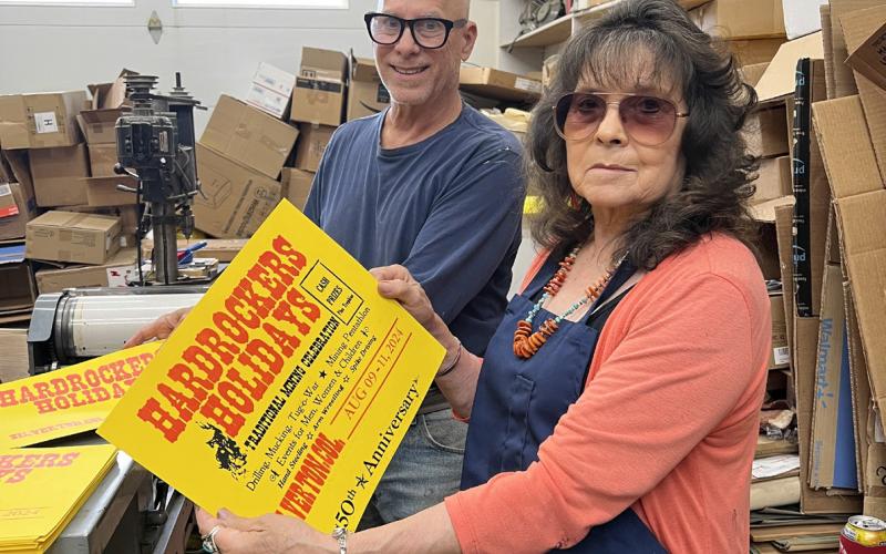 Judy Kuhlman and Tom Lanis work on the printing of the Hardrockers Holiday 50th Anniversary posters. Photo credit DeAnne Gallegos