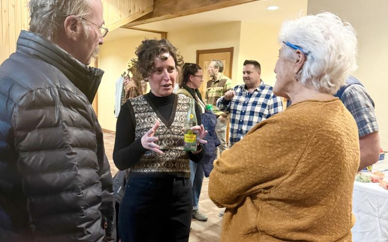 Elizabeth Stuffings chatting with San Juan County Commisioner Scott Fetchenheir &amp; com-munity member Sue Morris at candidate's night last December photo by DeAnne Gallegos