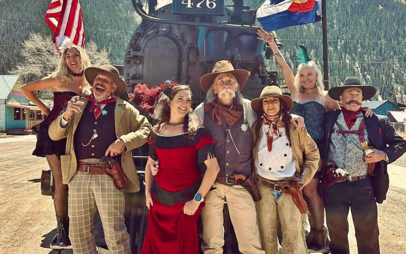 Group of western and Victorian characters pose with steam engine 476. Photo credit Misty French