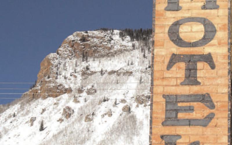 The Avon Hotel at the corner of Blair and 10th streets still advertises great rates, with snow-covered Anvil Mountain in the background. Photo: Mark Esper
