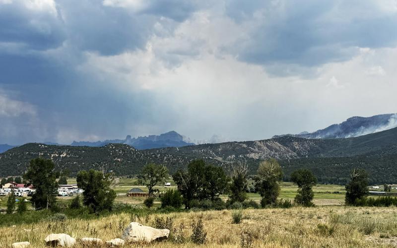 Part of the incident command post at the Ouray County Fairgrounds and the smoldering mountains behind it on June 14, 2026 Photo by Katey Fetch