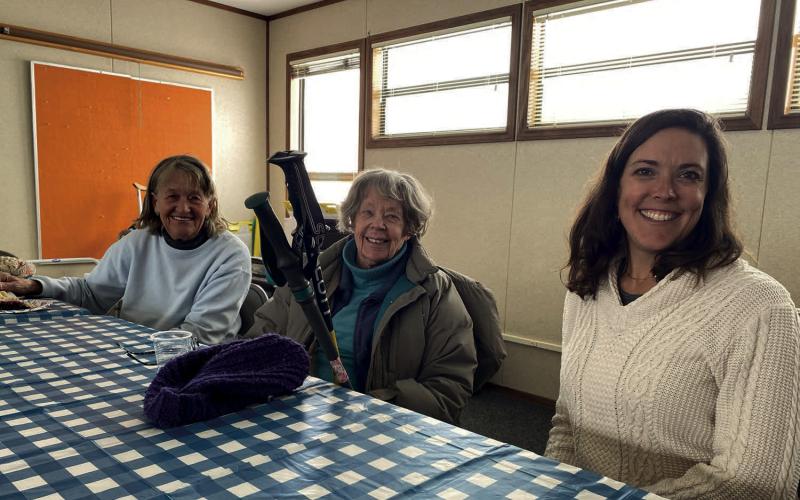 Seniors and volunteers sitting down together Photo provided by Becky Joyce