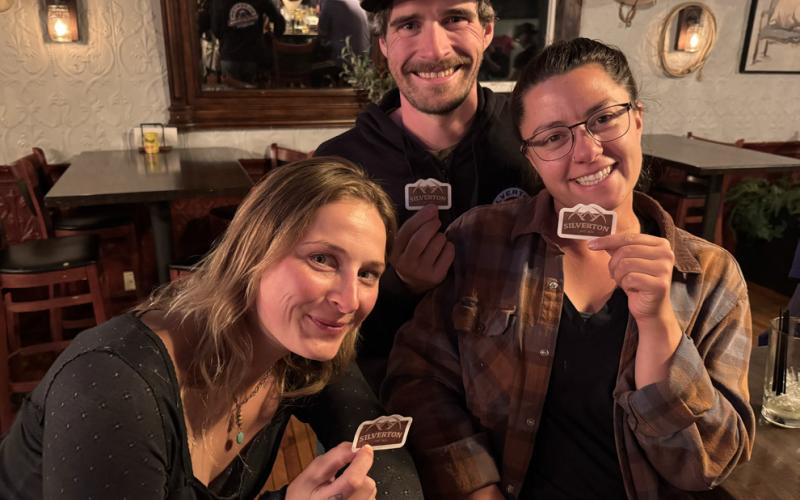 photo by Sarah Moore Silverton’s Aly Wiemken, Ryan McClure and Lindsey Halvorson attend the SJDA celebration party for the successful fundraising campaign for the new town entry sign.