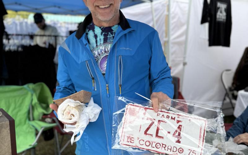 photo by DeAnne Gallegos Silverton local artist Phil Antonelli showed off his paper art of an old ZE licenses plate at the Silverton Creates Art Festival in Memorial Park.