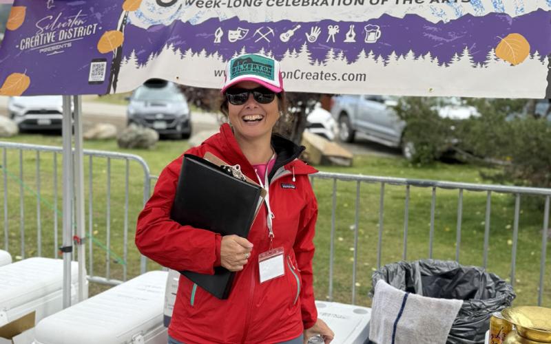 photo by DeAnne Gallegos Silverton Creative District Director Lisa Branner takes a quick moment to check on the drinks tent during the Silverton Creates Art Festival.