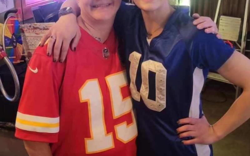 Photo by Alpine Tavern Keli Fries owner of Silverton Camera and Shiloh Sams owner of Alpine Tavern remain friends even after their “football rivalry”.