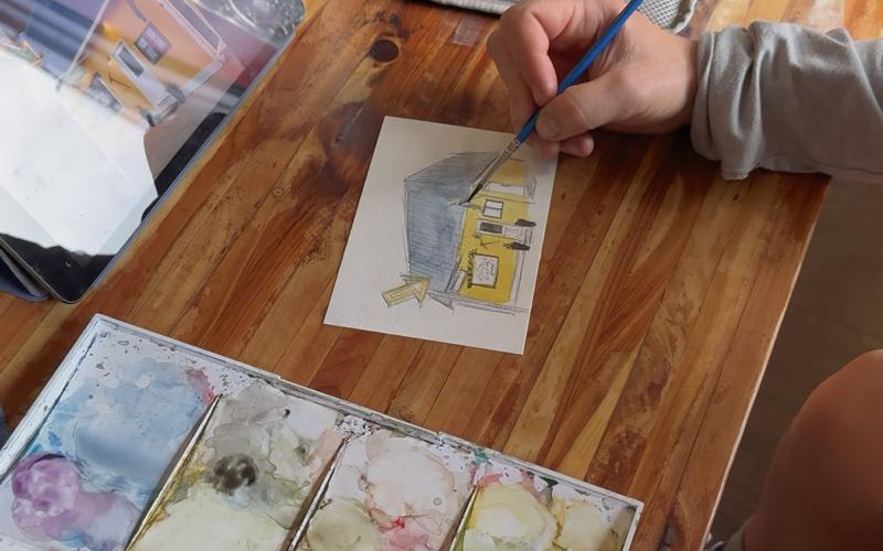 Local artist Nancy Stanley paints a watercolor of Dera Deli during the First Friday photo by DeAnne Gallegos