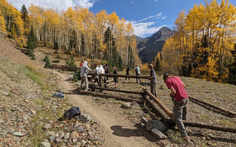 Building a fence amongst the fall colors on the Baker’s Park trail. Photo credit Silverton Singletrack Society
