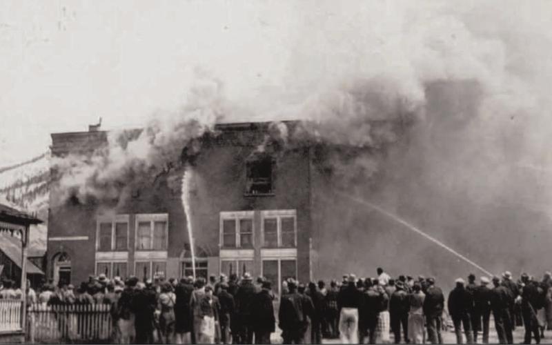 A group of people watch firemen put out a fire at the Avon Hotel rooms on May 8, 1938. Photo courtesy of San Juan County Historical Society