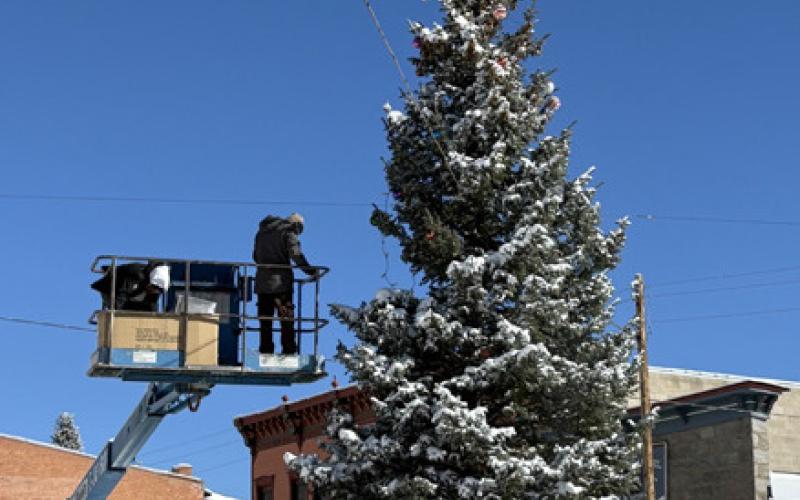 photo by Melanie Bergolc The Town of Silverton Parks and Rec Crew, Chris Gapsch, Jeff Rome, and David Swanson, decorate the Town Christmas Tree right in time for the Holiday