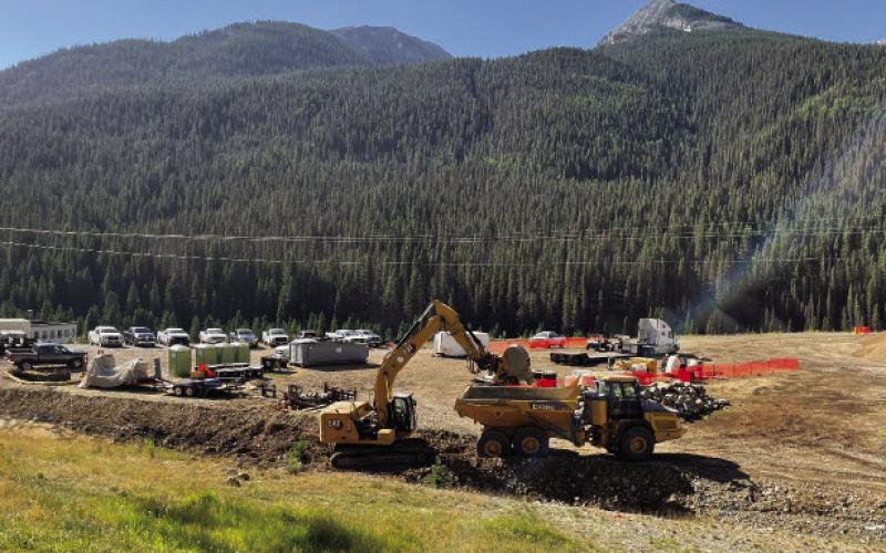 Excavator and dump truck excavating stormwater channel #6