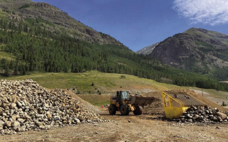 Screening cover material to generate riprap on-site rather than importing through town
