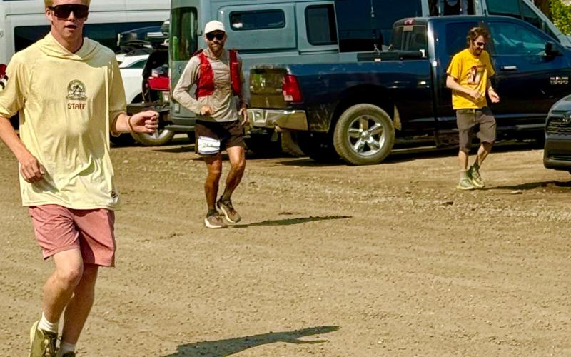 Silverton locals Phen and Steve Mead run with their longtime friend Ben Wyrick as he completes the Hardrock 100 photo by Missy Izard