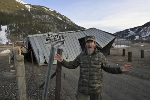 Fred the Weather Man in front of the San Miguel Power coop shed that got tumbled for more than 200 feet early Sunday morning