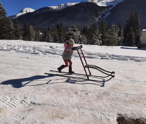 Photo credit Larry Raab Four year old Claudia kick sledding on Snowden Street.