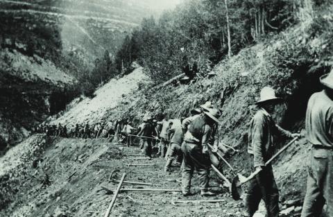 After the new Colorado Highway Department was asked to take over the former Otto Mears toll road from Ouray to Silverton in 1916, portions of the route were rebuilt to locations much higher above the Uncompahgre River to avoid frequent flooding. In 1918, this was how a new portion of the road high above the river was being constructed. It was tough, painstaking work by hand and with explosives. Colorado Department of Transportation Archives, Denver.