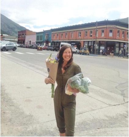 Myste French showing off farmers market goods. Photo by Kharis Weller