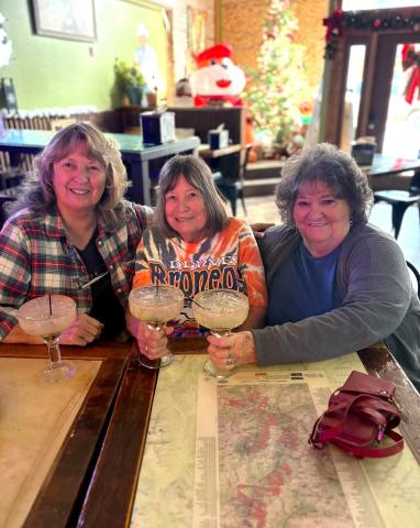 Longtime locals and multi-generational family Bingel sisters Charla Bingel Andreatta, Sue Bingel Sanders, and Patty Bingel enjoy the New Year, celebrating with the Alpine Tavern’s Gingerbread Margaritas photo by Charla Andreatta