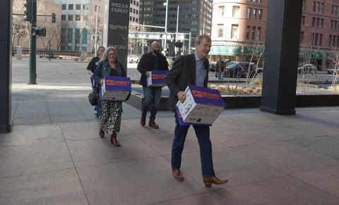 Michael Bennet &amp; his wife Susan walking in petitions with his team