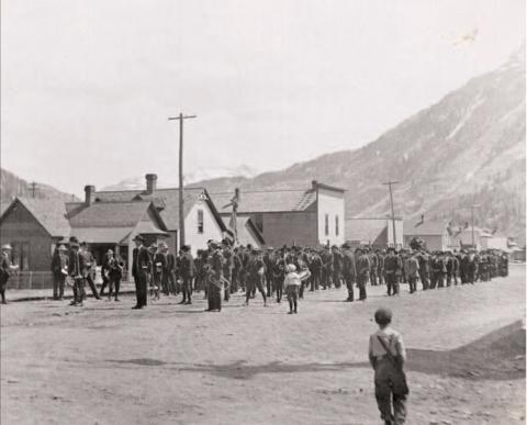 In the top photo, union men form on the 1000 block of Greene Street to march to the cemetery in June 1908 following the deaths of six miners in a fire at the Gold King Mine at Gladstone. A boys band lined up in front of the miners’ group. In the background can be seen the old Alamo Hotel and Curry’s store building. Photos courtesy of San Juan County Historical Society