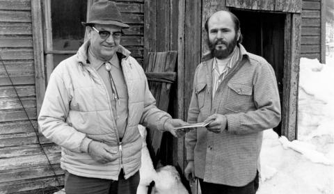 Ceremonial transfer of title to site of former Silverton Northern Ticket Office and Depot in Silverton from the Denver &amp; Rio Grande Western Railroad to the San Juan County Historical Society Roadmaster. Jack Rentfrow (left) hands documents to Society chairman, Alfred Klinke (right). Photo was taken on the Northeast side of the Silverton Northern Ticket Office and Depot on 10th Street. April 1976 Photographer: Larry J. Duthie Photo courtesy of the San Juan Historical Society