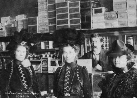 Photo courtesy of San Juan County Historical Society Barney Tocco at his shop at 1246 Blair Street, with three unidentified women in an undated photo. Barney opened the Piemonte store in 1909, carrying shoes, boots, dry goods, groceries and tobacco.