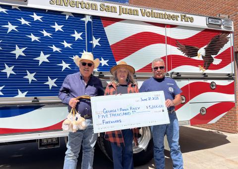 George and Anna Riley (left) donated $5,000 to the Silverton San Juan Volunteer Fire Department towards the fireworks show. Fire Chief Gilbert Archuleta (right side) accepted the check on behalf of the volunteer fire members. Photo credit DeAnne Gallegos