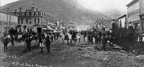 The 1891 Fourth of July float of Joseph Bordeleau, promoting his hardware store. View of the float and several individuals, taken directly in front of and facing the Bordeleau store front at 1139-1145 Greene. The float is a decorated wagon drawn by a 2-horse team and covered with signs and samples of the owner’s wares. Courtesy of San Juan County Historical Society