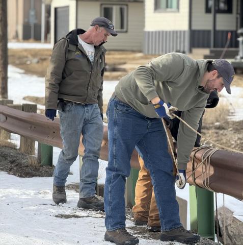 Town of Silverton crew lower the water pump photo by DeAnne Gallegos
