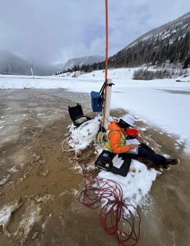 Collecting groundwater samples from a monitoring well on the Mayflower Mill Tailings Impoundment #4
