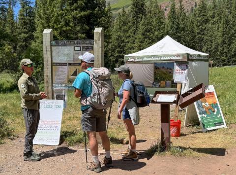 SJMA Forest Ambassador connecting with visitors at Ice Lake Trailhead photo by SJMA