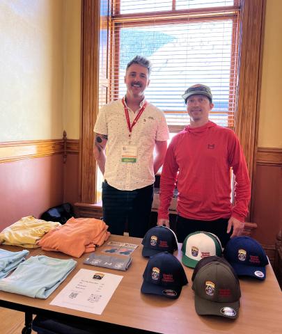 SMR volunteers Brenden Goetz and Billy Grimes man the swag table at the MMS. Photo credit DeAnne Gallegos