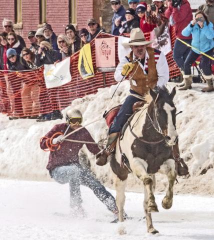 Skier and cowboy racing down Blair Street. Photo from Silverton Skijoring Facebook Page