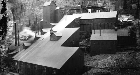 Ore processing buildings on a steep slope in San Juan County, Colorado. This Iowa Mill complex consists of multi-story, frame stamp mill buildings, smokestacks and support structures located in the Arrastra Basin near Silverton, Colorado. Benjamin W. Thayer and James H. Robin were involved in the development and operation of this facility in the late 1880s and 1890s. Photo Courtesy of Cindy Buckner