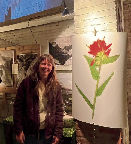Hannah Green standing next to her artwork. Photo by DeAnne Gallegos