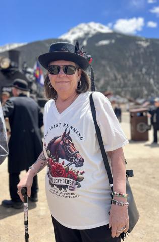 Handlebar Holly, who is now the owner of the Shady Lady Saloon, was wearing her Kentucky Derby best while greeting the train. Photo credit DeAnne Gallegos