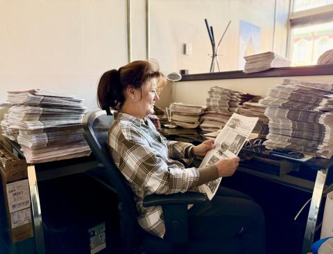 H.H. Smith's great granddaughter Susan Haupert sits in the current Silverton Standard's office and catches up on some recent newspapers photo by DeAnne Gallegos