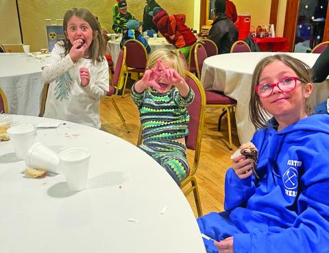 Ella and Val Anderson, with Alida Mead enjoying the potluck at Kendall Night Ski. Photo by Misti Anderson