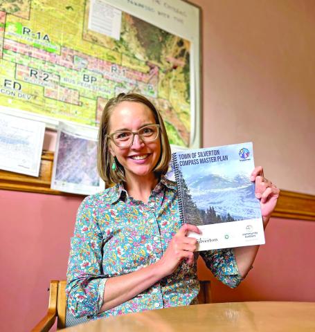 Town Administrator Gloria Kaasch-Buerger holds up the Town of Silverton’s Compass Master Plan. Photo credit DeAnne Gallegos