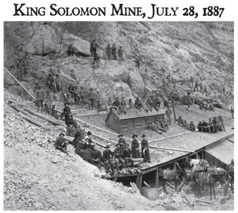 Photo of horseback trip taken by group called the Silverton Walking Club, to the mines on King Solomon Mountain. Party posed with miners and workmen at the North Star - King Solomon Mine above timberline. Several saddled horses in the foreground, including a white one with a man standing amid the horses. Women are posed with the workmen - they are on the left side of the photo. San Juan County Historical Society photo