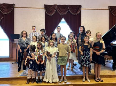 Photo credit Barbara Burtner Students of Lacey Black and Rebekah Soued-Weaver with their teachers at town hall recital.