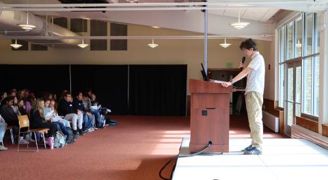 Jack Purcell starts the 7th annual youth summit with opening remarks and a land acknowledgement