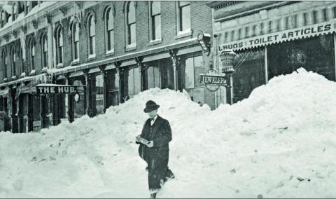 Good day, Sir. A nicely dressed, but unknown man walks through an apparent cut in the snowbank on Greene Street in front of the Grand Hotel, left, and Cunningham &amp; Crocker Drugstore, right. The sign for the Hub Saloon can be seen. What debauchery happened there? The photo comes from the archives and is believed to have been taken in 1906. Photo: Archival photo from the San Juan County Historical Society