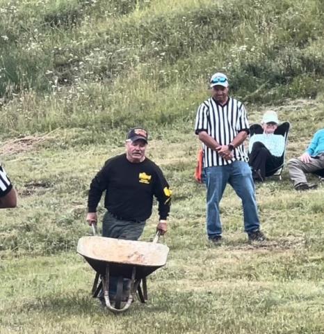 Terry Rhoades competing in the wheelbarrow race. Photo credit DeAnne Gallegos