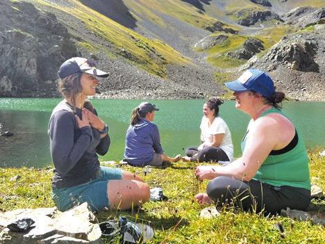 Women connecting at a glacier lake during the Silverton, CO New Moon Hike
