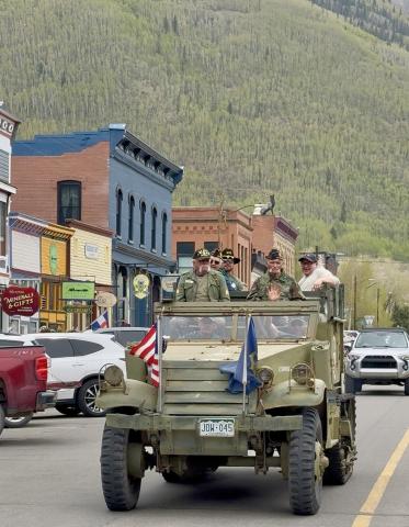 Local veterans ride the vintage halftrack down Greene St on Memorial Day photo by DeAnne Gallegos