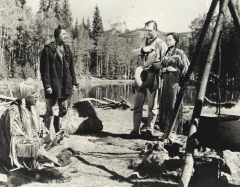 Clark Gable as Flint Mitchell and Maria Elena Marques