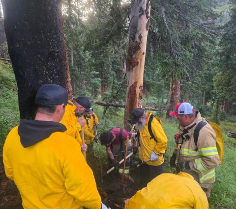 Volunteer fire department members ensuring tree fire is out photo by JP Stanley