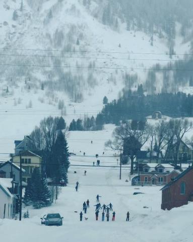 Locals playing on the road below Shrine Hill during the snowstorm. Photo credit DeAnne Gallegos