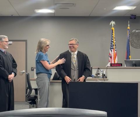 Jane Edwards adjusts her husband, San Juan County Judge Anthony Edwards, robe before his swearing in ceremony at the Archuleta County Courthouse in Pagosa Springs on November 13th, 2025, Judge Reid Stewart is on the far left. Photo by Jane Edwards